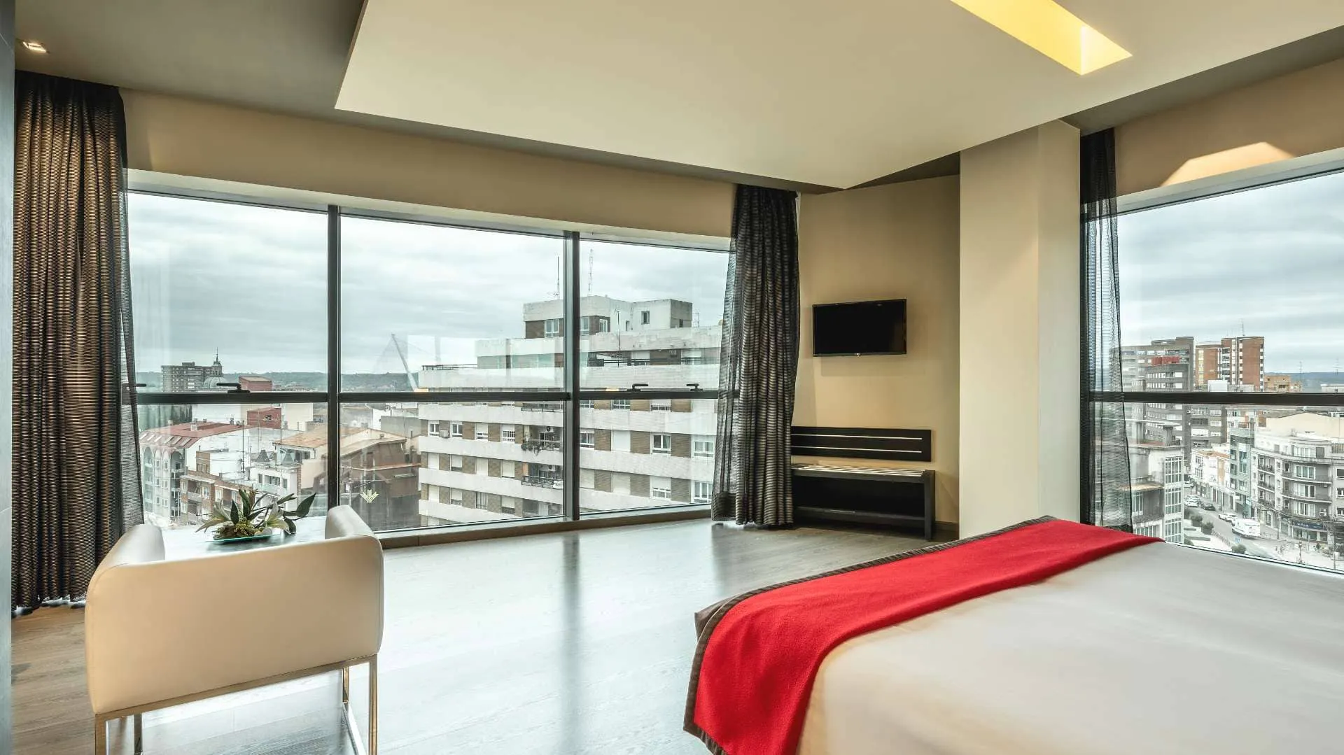Interior de habitación Doble Superior del Hotel Talavera con elegante decoración contemporánea, iluminación cálida y vistas panorámicas